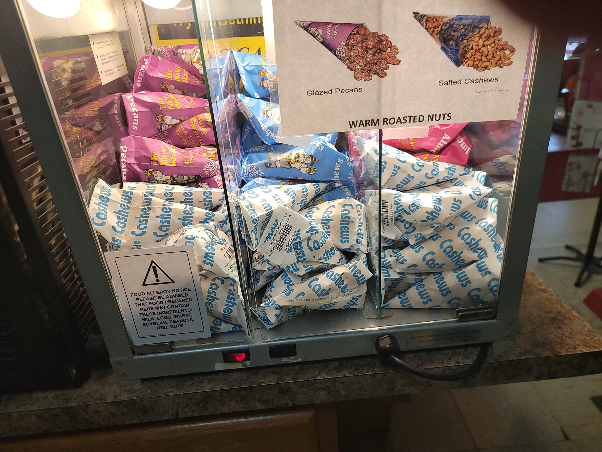 Warm roasted nuts display with glazed pecans and salted cashews